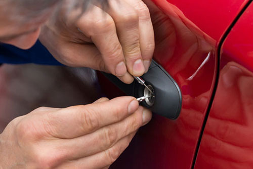person picking car door lock in emergency situation
