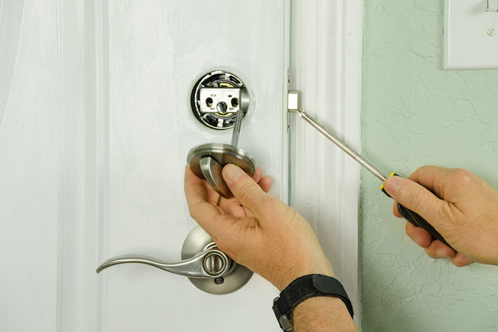 inserting a key into a residential door lock in St. Peters