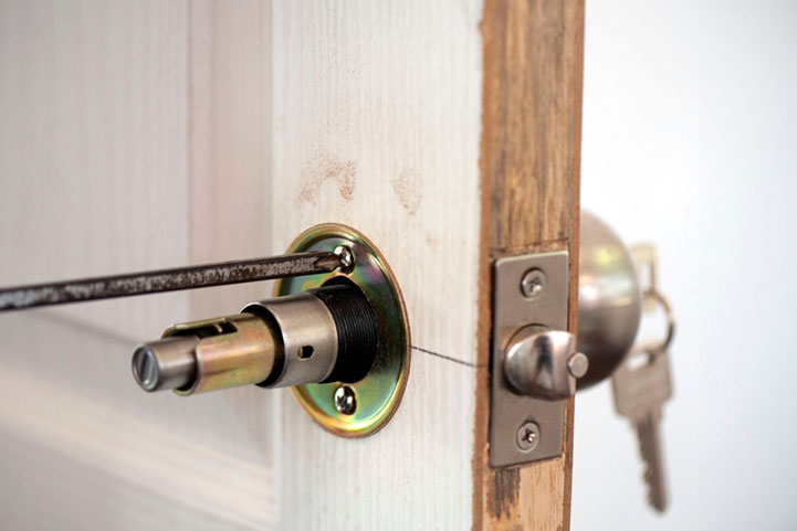 key being inserted into a secure door lock