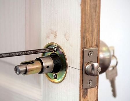 key being inserted into a secure door lock